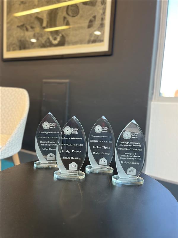 Four glass awards on a table